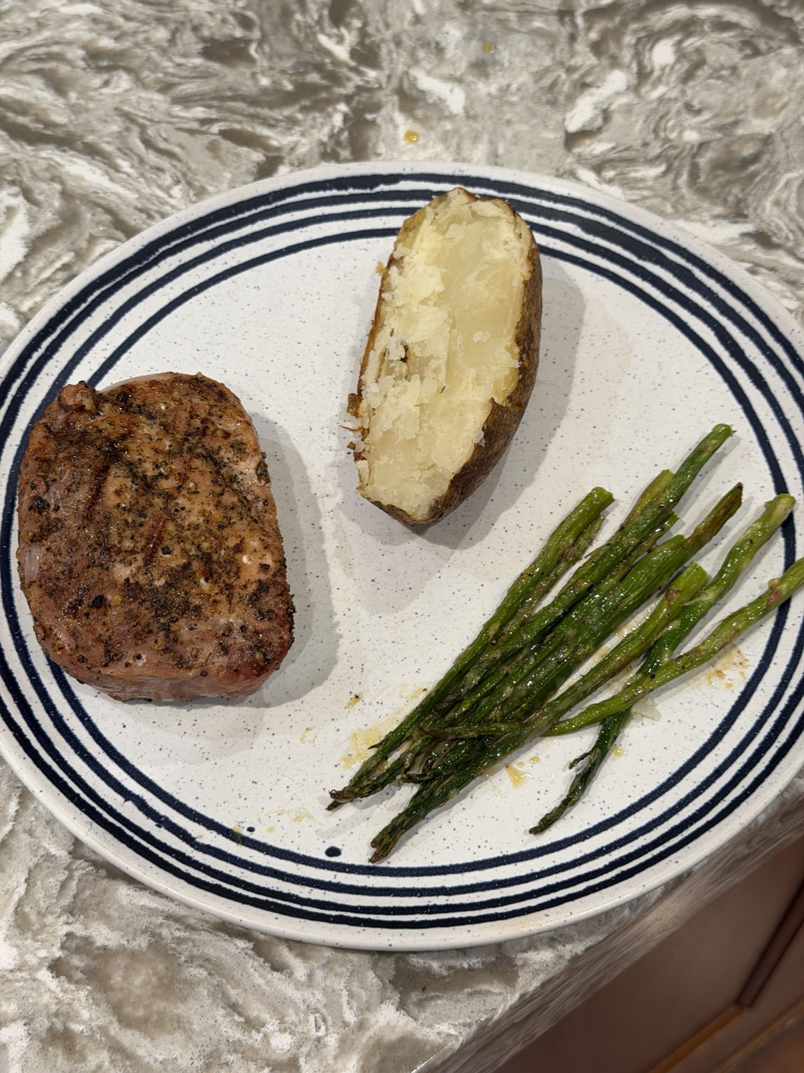 Roasted asparagus with Dijon glaze served with a bourbon-brined grilled pork chop and baked potato